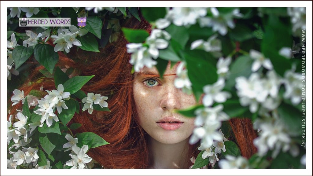 a woman half hidden behind a flower bush